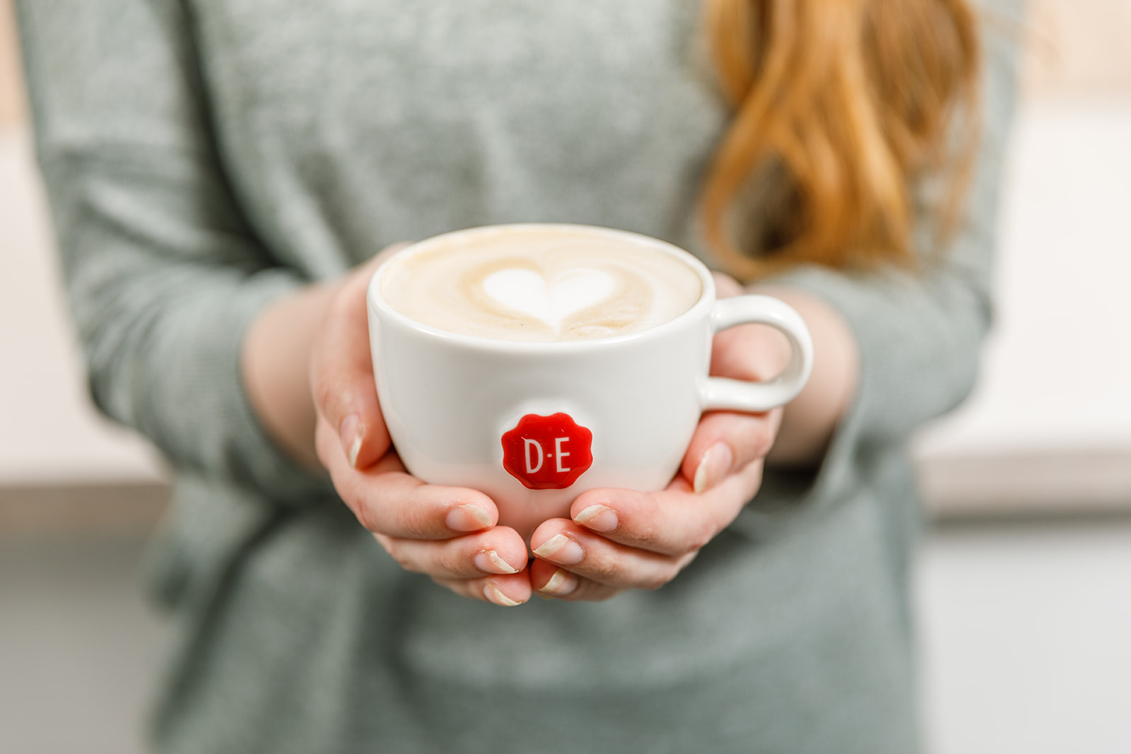 Woman holding cappuccino